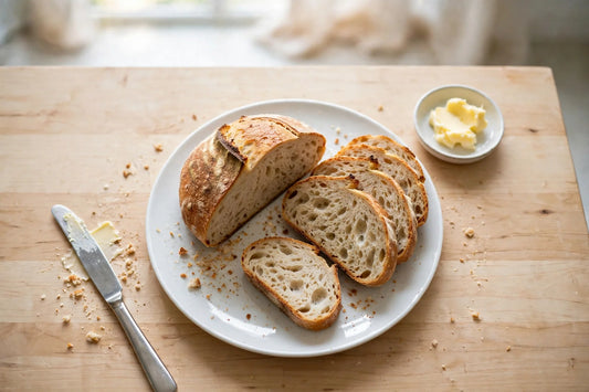 Freshly baked sourdough loaf sliced on a plate