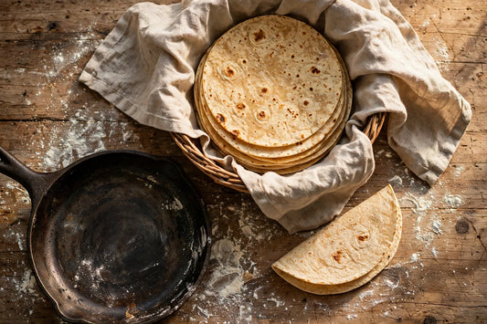 Stack of warm flour tortillas in a cloth-lined basket