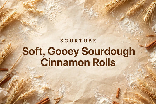 SourTube featured image: Soft, Gooey Sourdough Cinnamon Rolls title on a warm bakery background with wheat and cinnamon