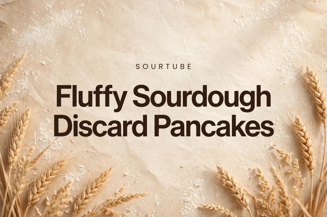 SourTube featured image: Fluffy Sourdough Discard Pancakes title on a warm flour-dusted bakery background
